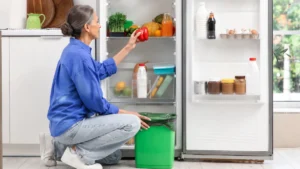Foods you shouldn't refrigerate displayed near an open refrigerator, highlighting common storage mistakes that ruin freshness.