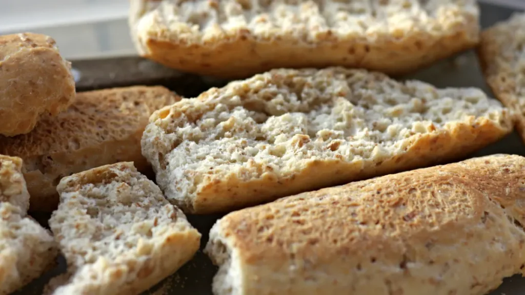 Close-up of stale sliced bread with a dry crumb texture, illustrating how refrigerator storage speeds bread staling.