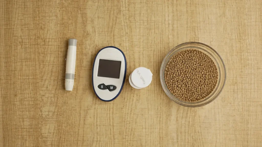 Blood glucose monitor and lancet beside a bowl of lentils, illustrating how low-glycemic legumes help prevent blood sugar spikes.