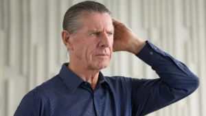 Older adult appearing forgetful and deep in thought, representing age-related memory concerns and cognitive health.