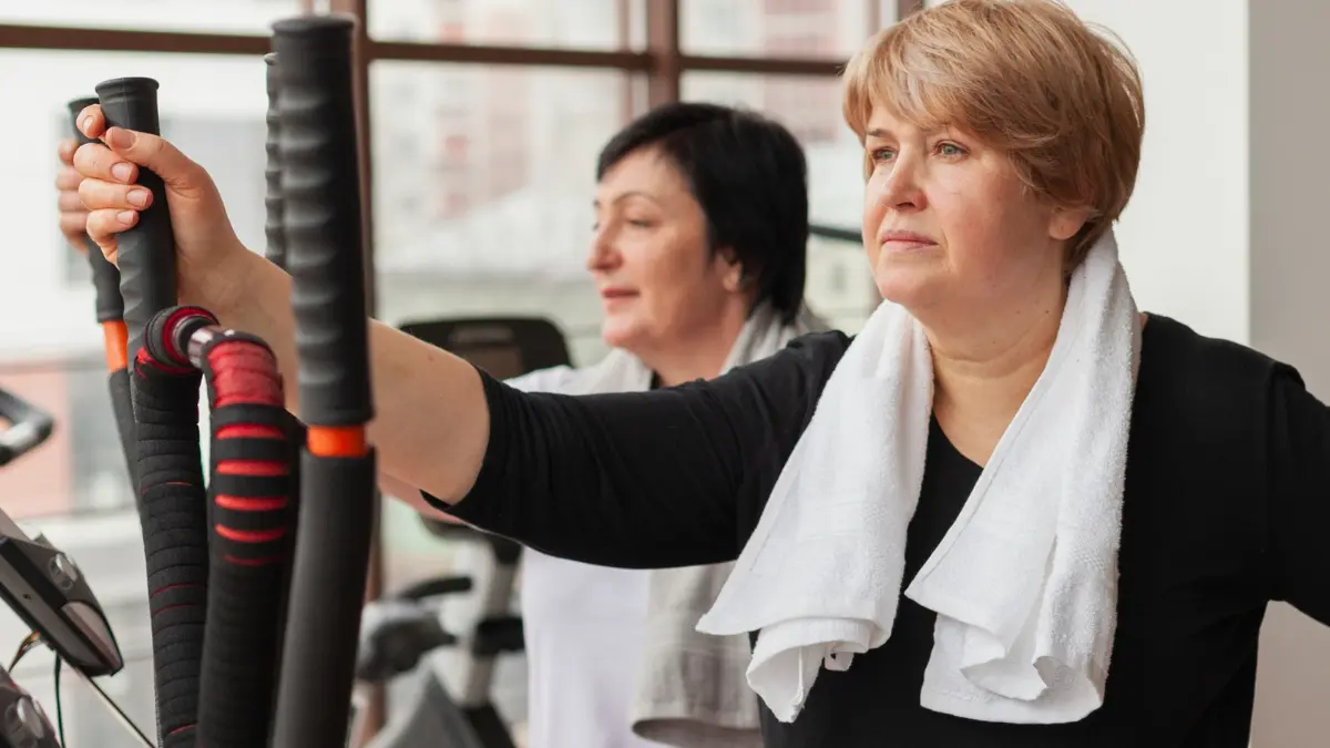 Iron deficiency fatigue in woman pausing during gym workout with heavy legs and low energy