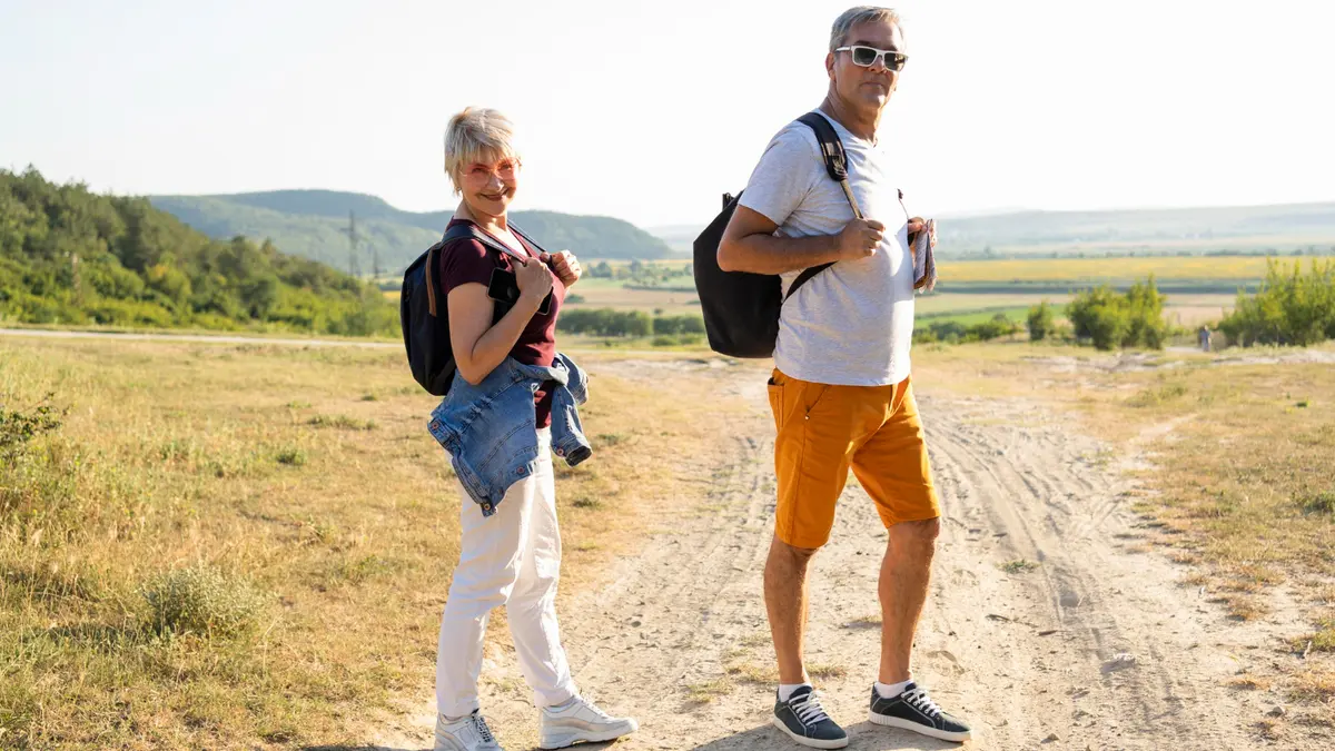 Active older couple enjoying an outdoor walk, illustrating how daily movement supports brain health, memory, focus, and aging.
