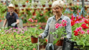Mature woman with golden hair smiles while tending to herbs in a 30-inch high elevated wooden garden