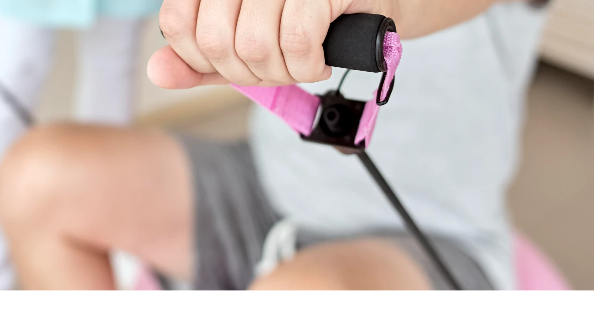  Man performing a grip test at the gym using a grip puller tool, squeezing his hand to measure strength.