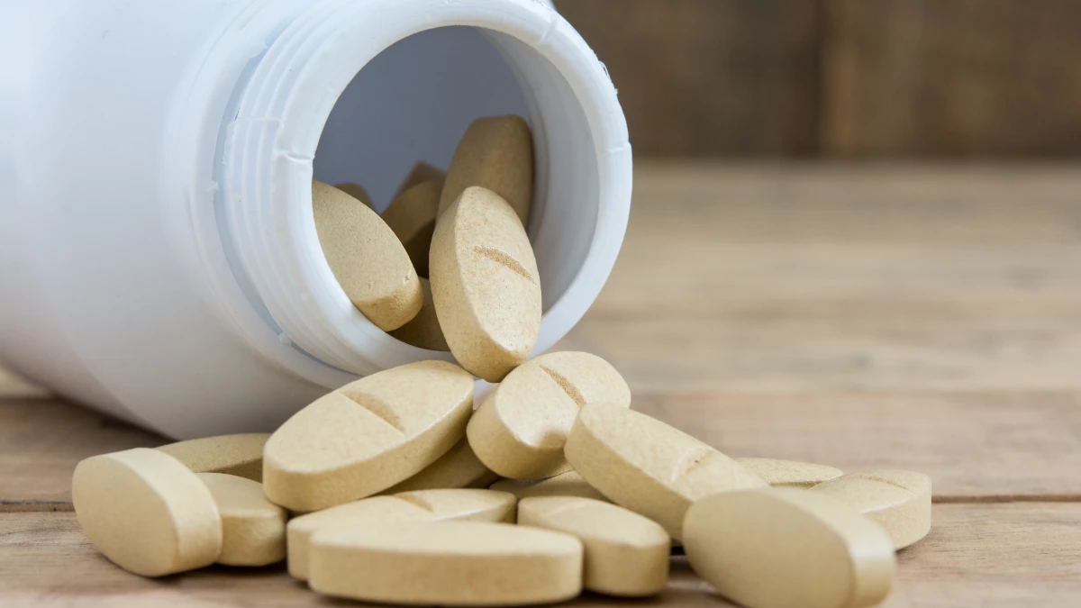 White B12 tablet on a sunlit clinic table, helpful for patients choosing between Methyl vs. Cyano supplements.