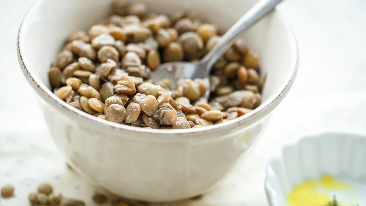 Sticky fermented soy natto beans served in a ceramic bowl, providing Vitamin K2 to support skeletal health.