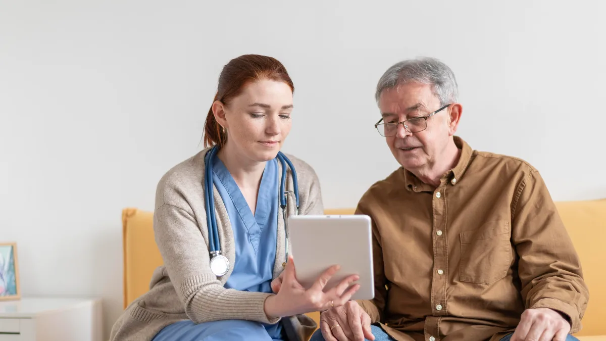 senior man in his 50s discussing kidney health tests like a 24-hour urine collection with female doctor during check-up
