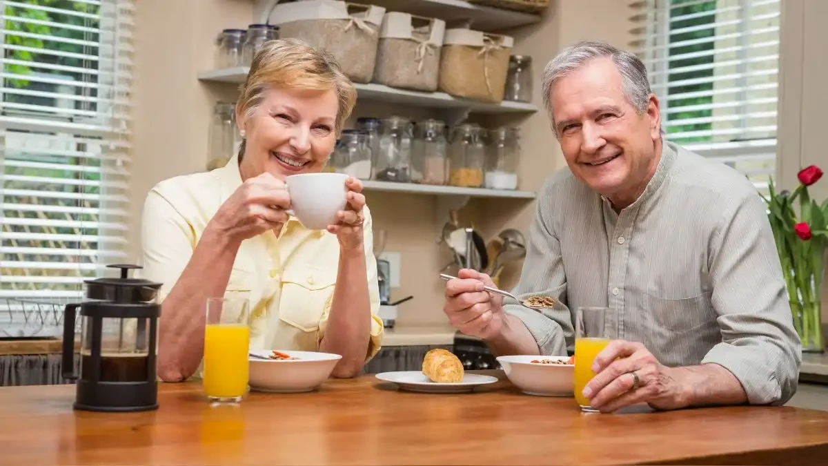 Active couple over 60 enjoying high protein breakfast to support muscle protein synthesis and healthy aging.