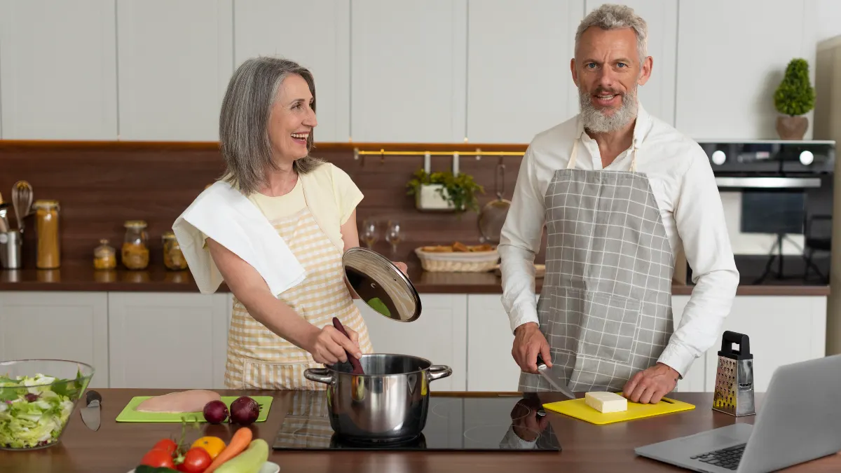  A happy senior couple ready to steam vegetables to secure pain-relief benefits by avoiding high heat and deep-frying