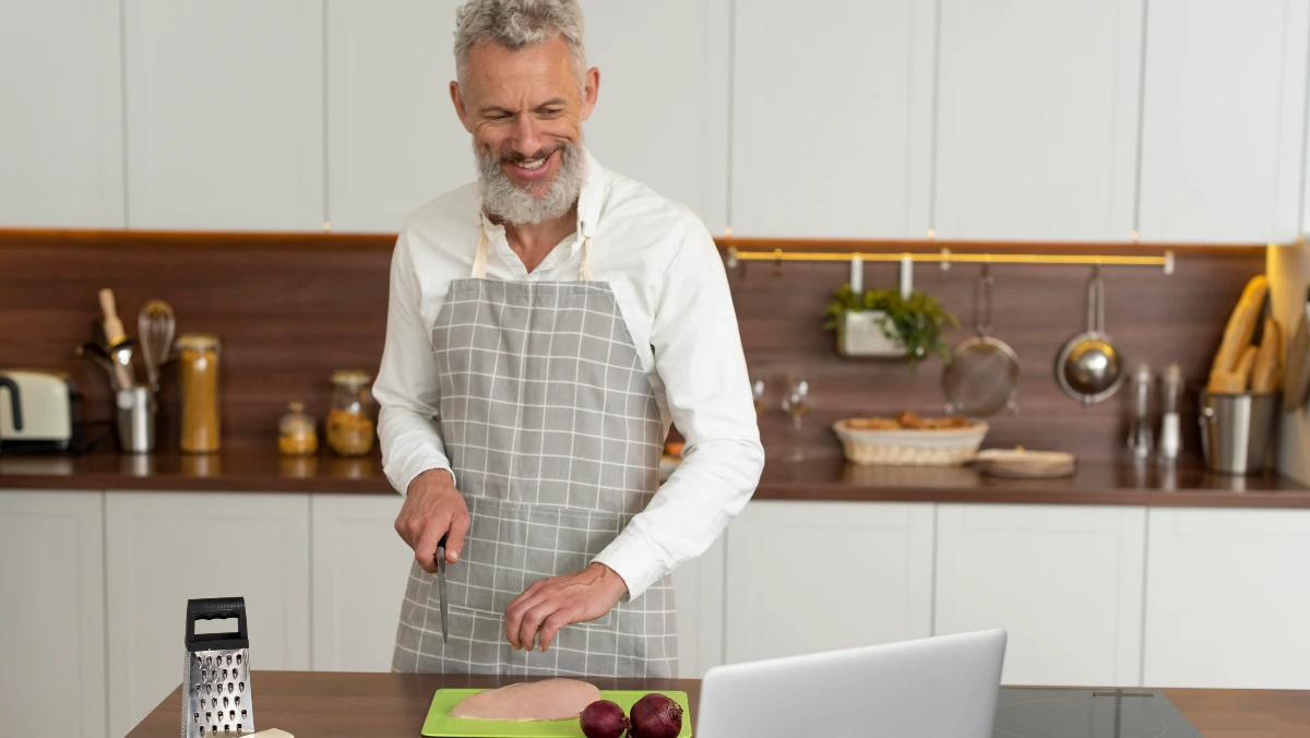 Fit man in his 50s preparing a healthy dinner to boost testosterone levels for overnight muscle recovery