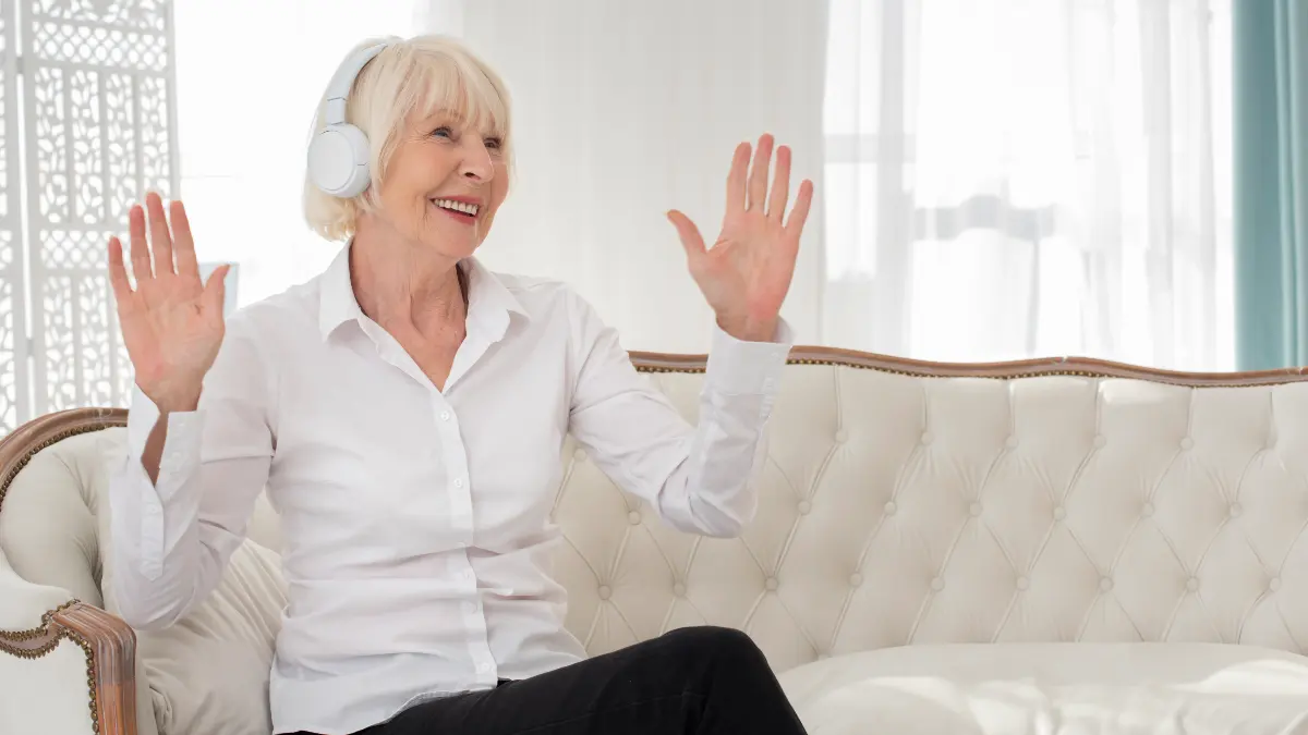 Woman in her 50s lies on a lounge chair under a thick, grey weighted blanket while resting