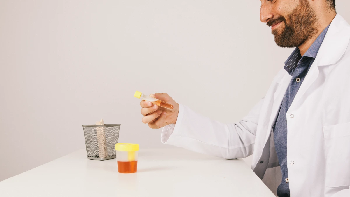 A medical professional examining a sample as part of a 24-hour test to diagnose and prevent kidney stones.
