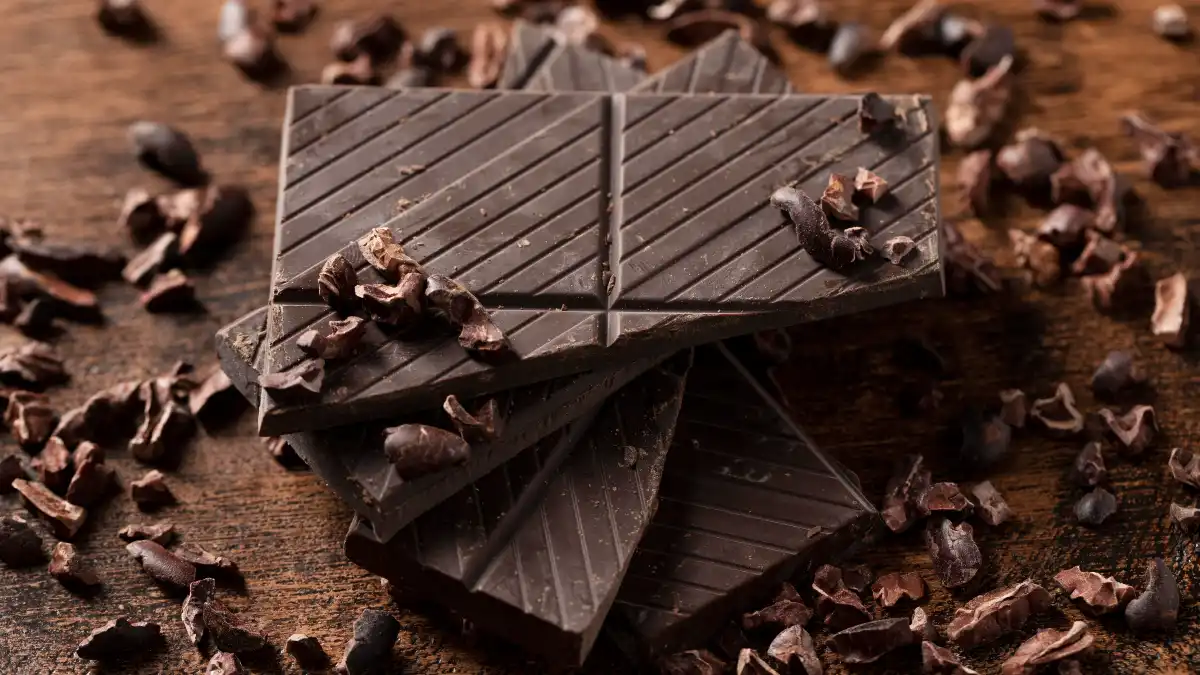 Dark chocolate on a table, essential foods for nitric oxide and healthy blood vessels.