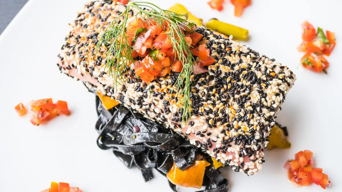 Seared Atlantic salmon served with leafy greens and pumpkin seeds to help free testosterone and recovery