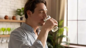 Man drinking a glass of fresh milk in the morning, partner nutrient to help bones work as they did at 40.
