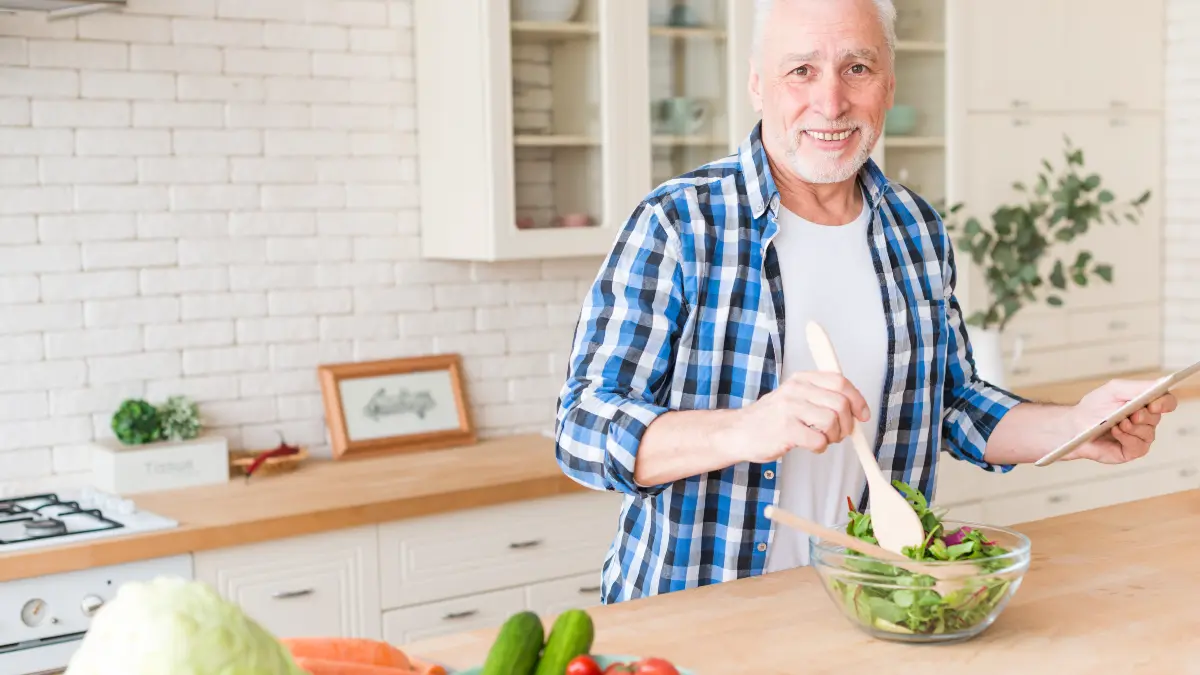 Senior man preparing plant based protein meal to support muscle mass and fight sarcopenia on vegan diet.