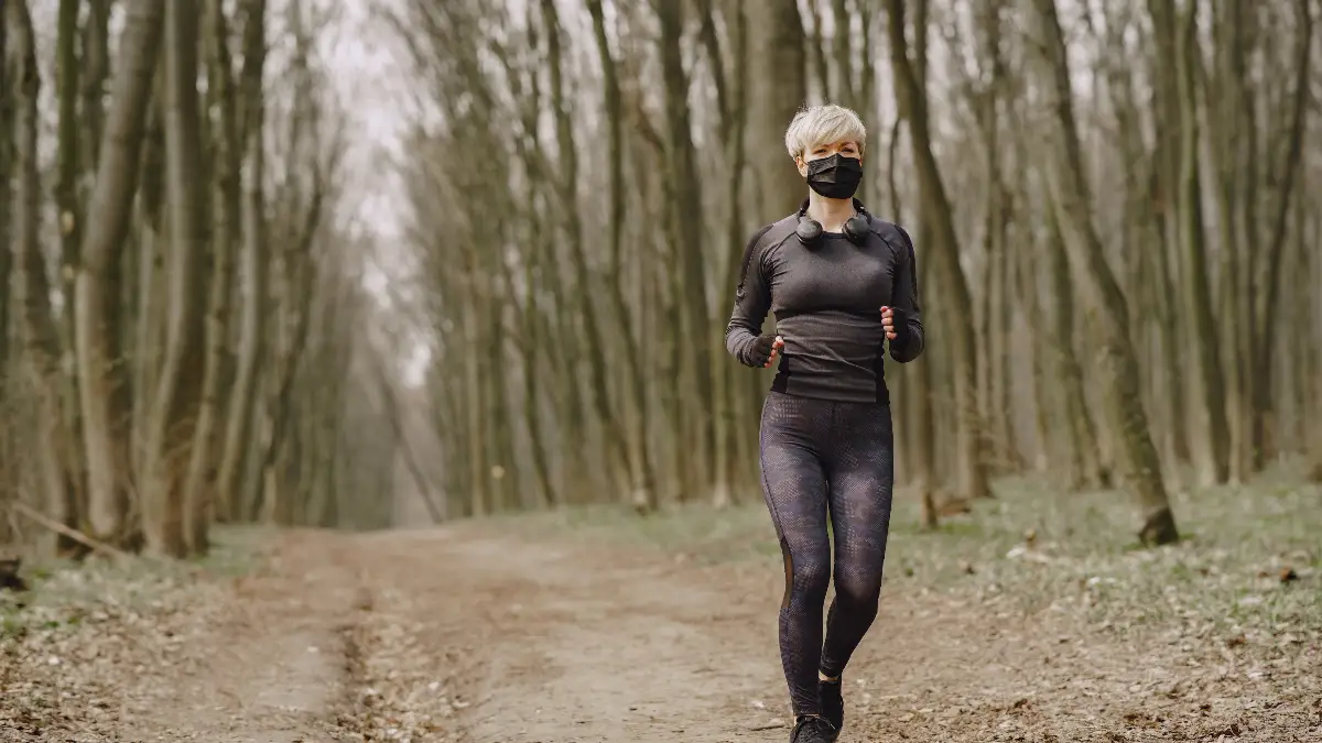 Mature woman walking at a leisurely pace to facilitate cortisol management and flush metabolic waste.