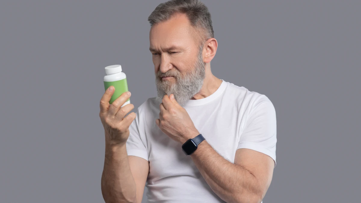 Omega 3 Index Test supplement bottle turned to back label as adult checks EPA and DHA amounts