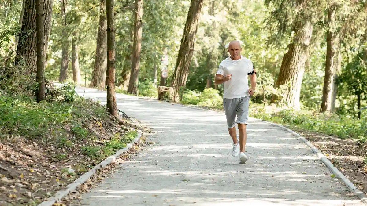 Active man in his 40s jogging through a lush green park in the morning, supporting bones with Vitamin K2 nutrients