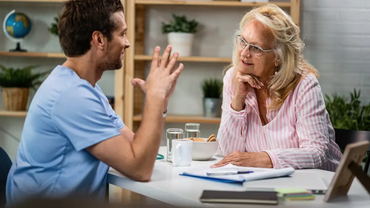 Senior woman consulting doctor about asthma and breathing exercise safety before starting 4 7 8 technique at home.