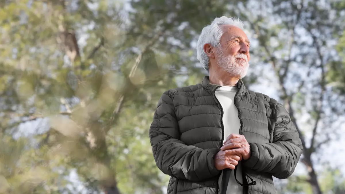 Senior man enjoying morning sunlight outdoors as natural way to release nitric oxide and soften arteries