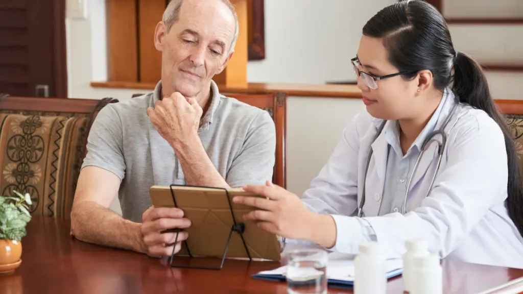 Doctor and senior patient reviewing cholesterol lab report together, standard LDL test may miss real heart risk