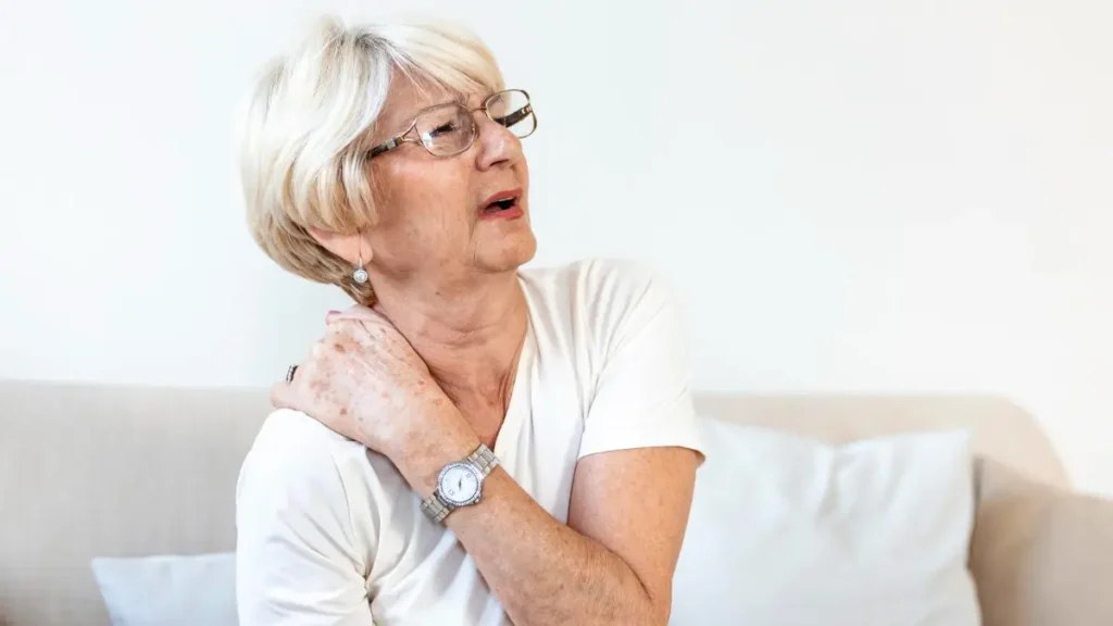 Mature woman feeling the physical grip of tension while supporting her basal metabolic rate through rest.