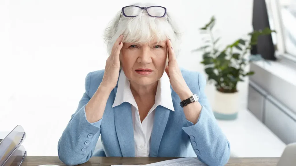 Frustrated woman in her 50s managing cortisol levels while experiencing persistent midday brain fog.
