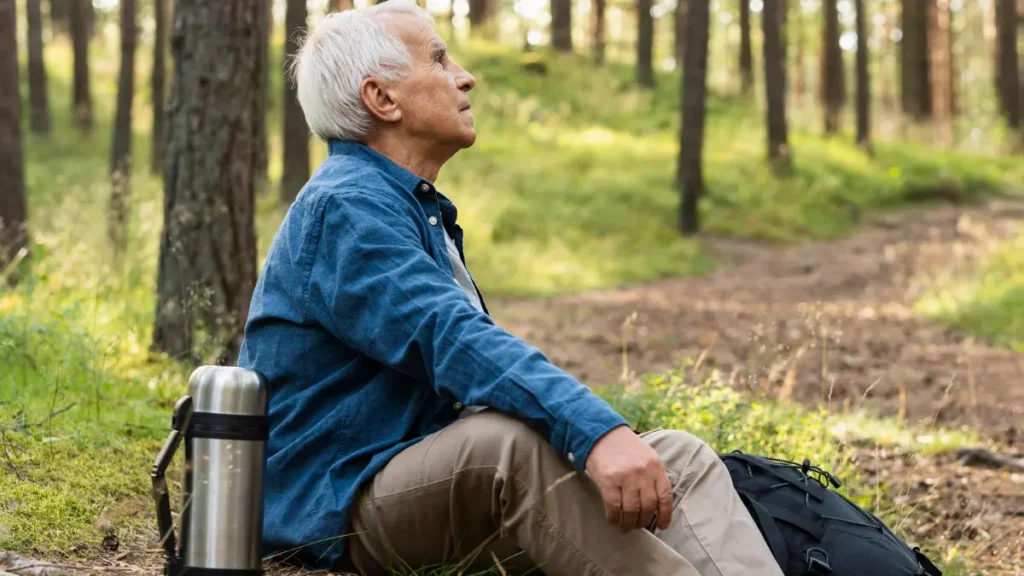 Older man pausing during a walk to address shortness of breath and arterial elasticity.