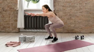 Mature woman performs a controlled bodyweight squat with arms extended forward to improve lower body strength and maintain mobility.