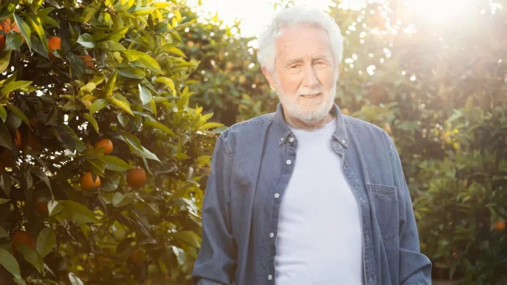 Mature man standing in morning sunlight to anchor his circadian rhythm and manage 3 AM cortisol spikes.