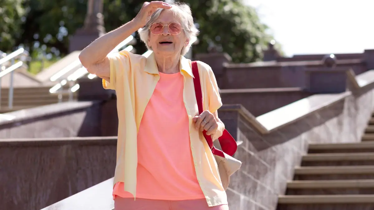 Active senior woman navigating outdoor stairs to improve knee joint trust after 50.