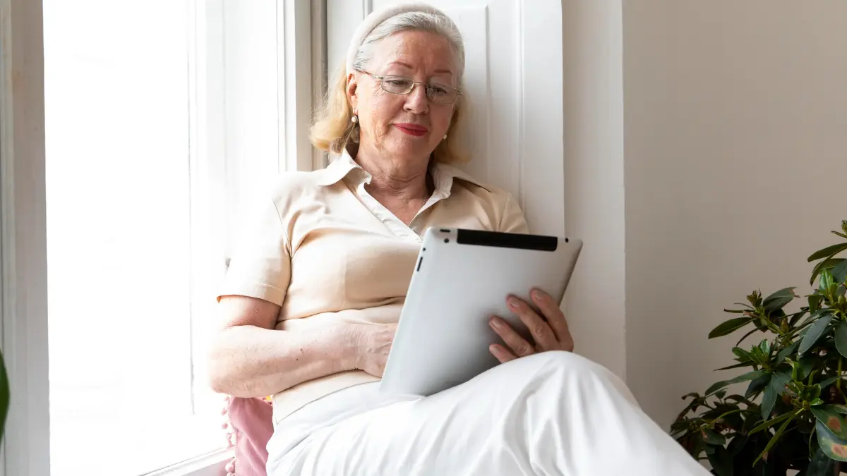 Mature woman reviewing her health records to improve immune resilience after 50.