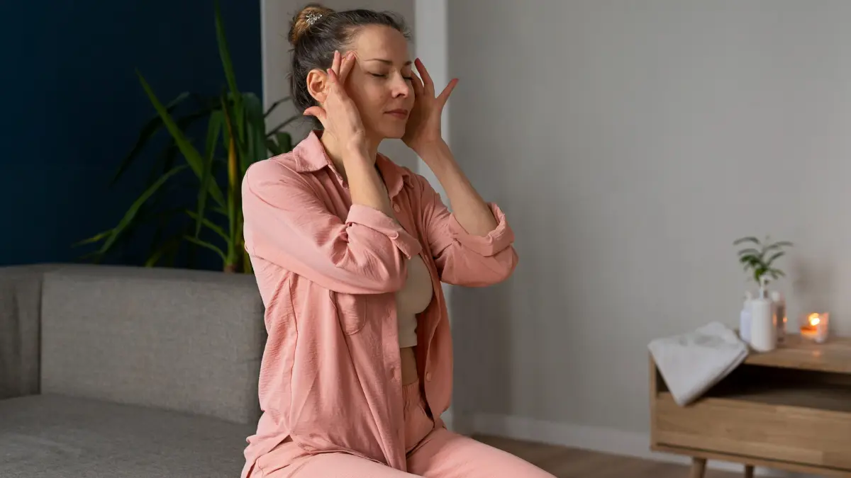 Mature woman practicing somatic exercises to support cortisol management and release trapped physical tension.