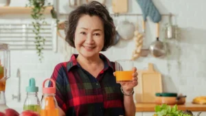 Vibrant mature woman enjoying a healthy meal to support digestive enzymes after 50.