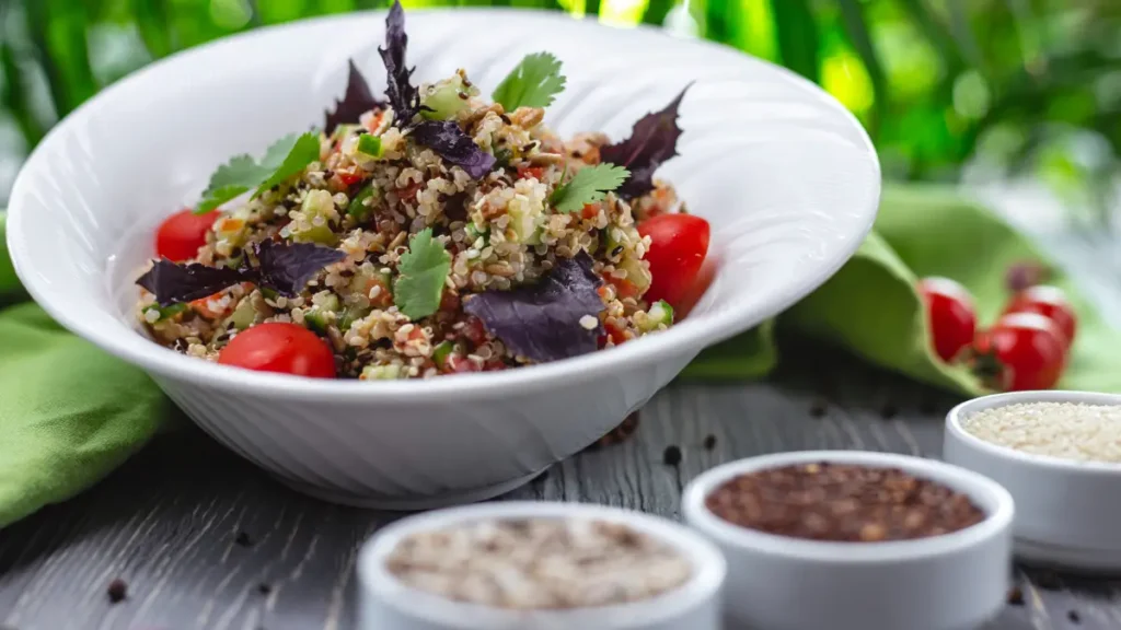 Fresh quinoa salad with cucumber and tomato served to refill muscle glycogen stores and prevent post-workout energy crashes.