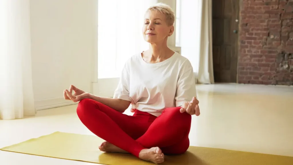 Mature woman practicing deep belly breathing to support cortisol management and enzyme release.