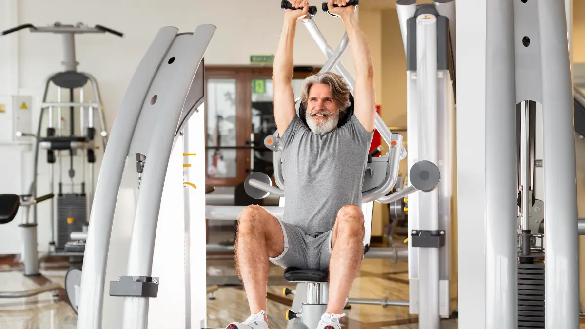 A mature man maintaining grip strength through hanging exercises to support long-term longevity.