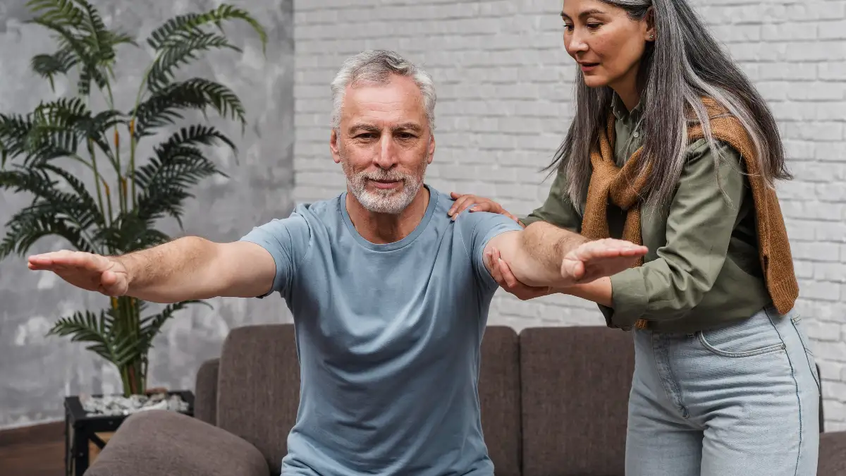 Mature man performing balance stabilization exercises during a VRT session to improve sensory reweighting and metabolic cellular energy.