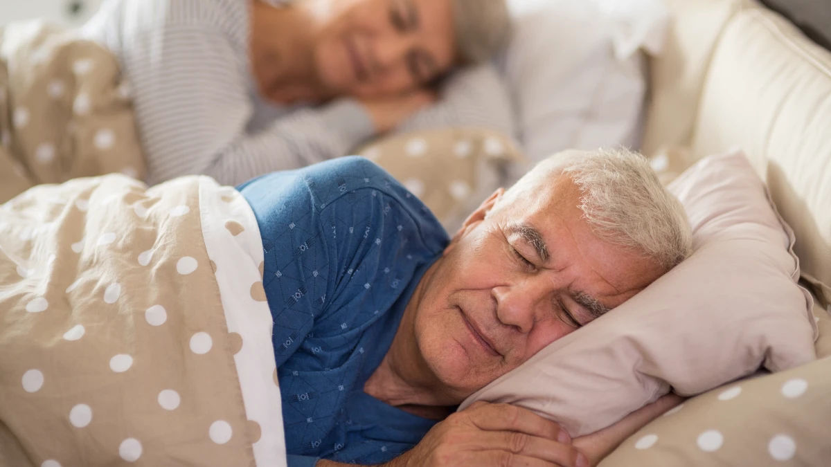 Mature man in deep sleep to facilitate cortisol management and allow his liver to perform essential metabolic cleaning.