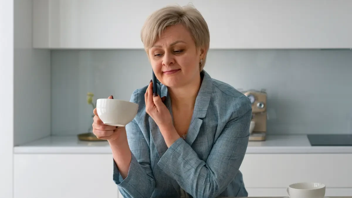 Mature woman drinking tea to avoid metabolic confusion and support her basal metabolic rate by skipping artificial sweeteners