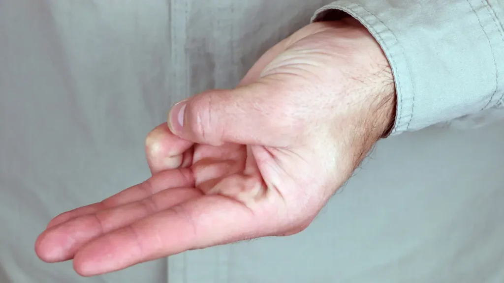 Detailed view of a mature hand connecting the thumb and pinky finger tips to restore dexterity and prevent dropping objects.