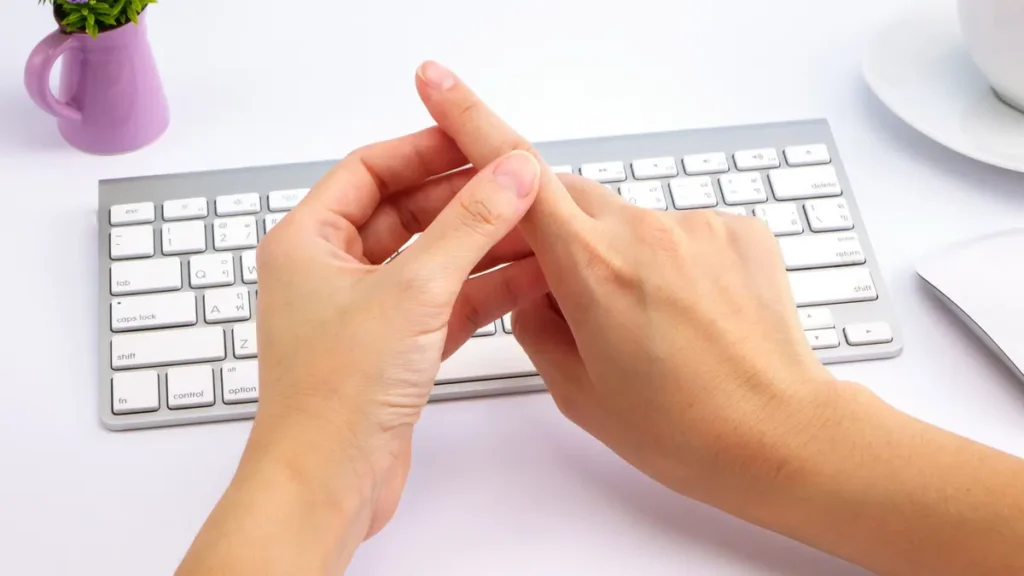 Woman rubbing her index finger to restore circulation and manage carpal tunnel numbness caused by wrist inflammation.