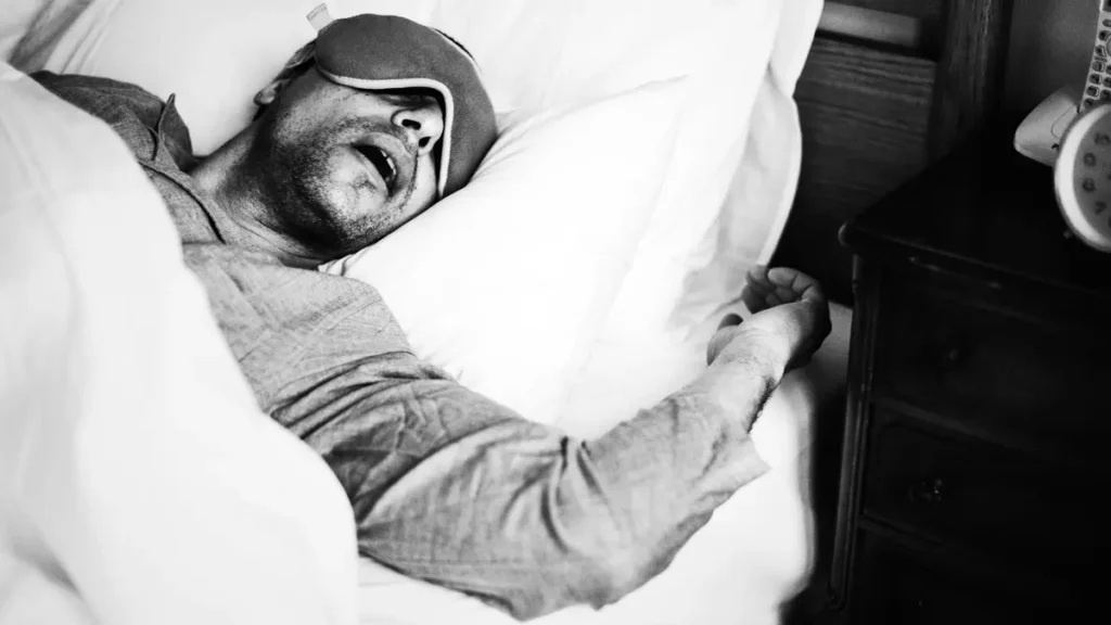 Man sleeping deeply at night, showing how quality sleep supports muscle repair and joint recovery after exercise.