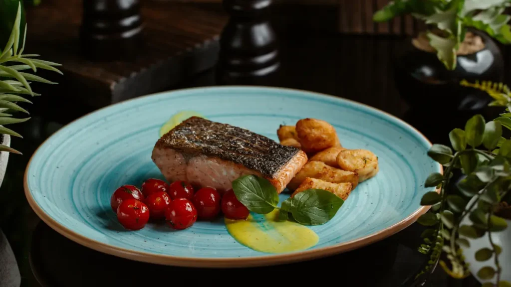 Grilled salmon fillet served on a plate to deliver the high protein intake needed to support basal metabolic rate over 50.