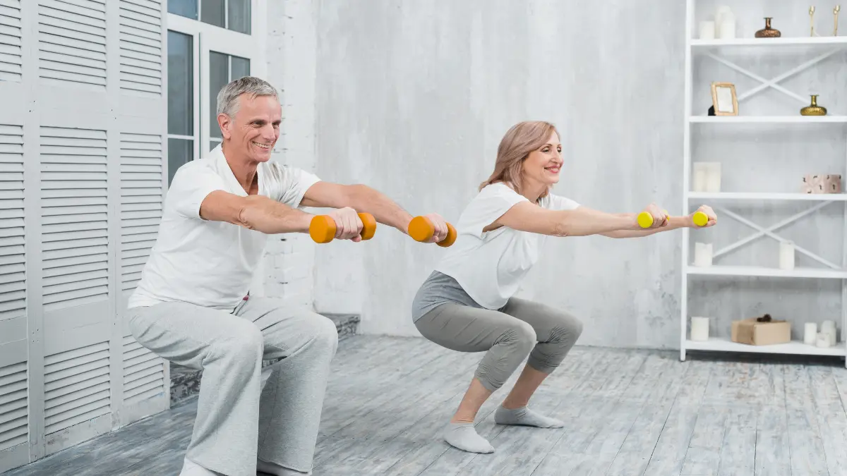 Active mature couple performing joint-friendly strength training with light weights to prevent sarcopenia after 50.