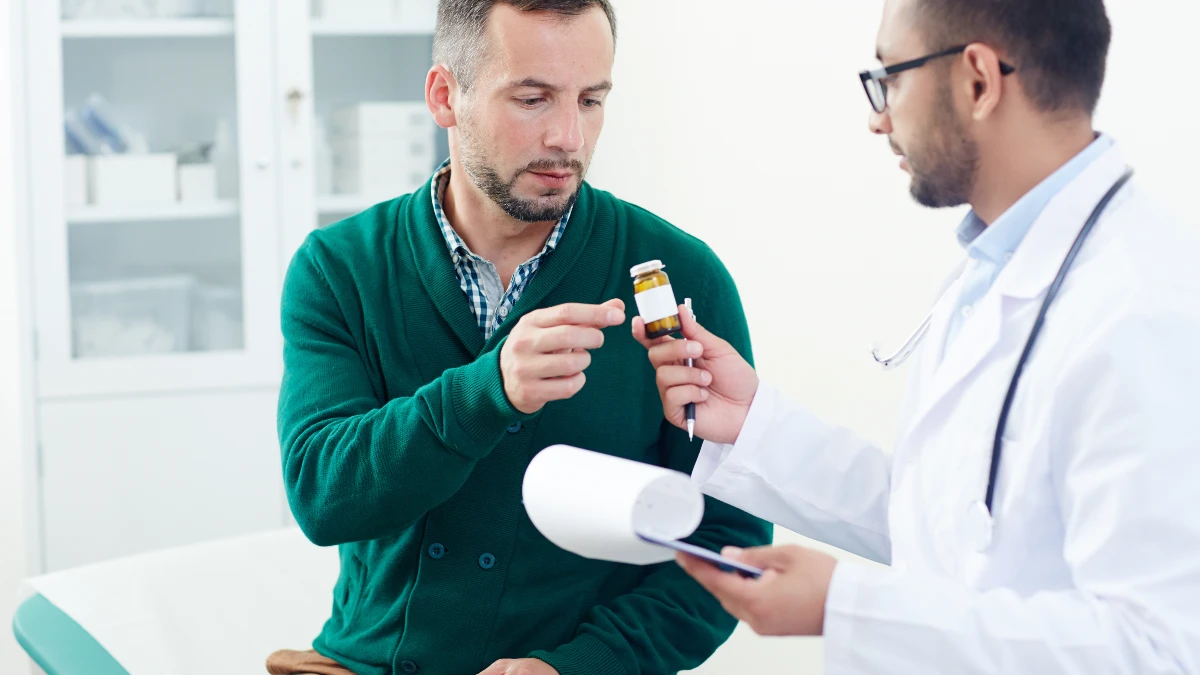 Man discussing supplement safety with a healthcare provider during a clinical consultation for nitric oxide support.