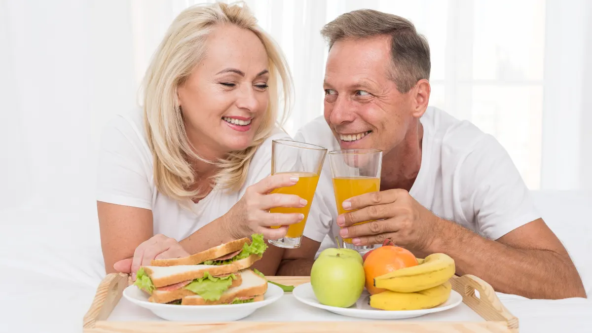 Mature couple enjoying a high-protein breakfast to improve basal metabolic rate and combat age-related muscle loss.