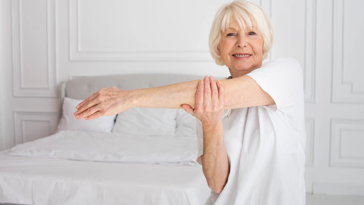 "Mature woman performing a gentle morning stretch protocol to ease joint stiffness after 50