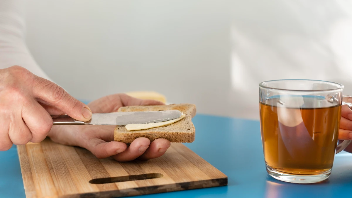 Hands preparing white bread and a soft drink which can block magnesium absorption and lead to deficiency.
